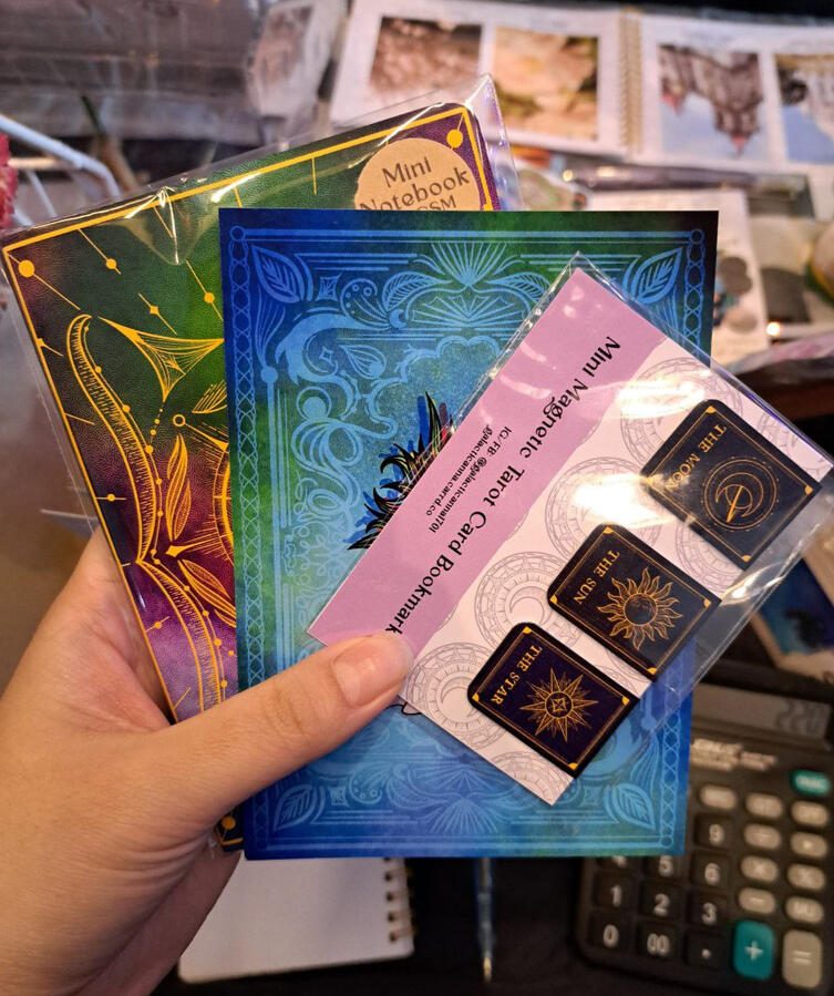 Our products! Featuring one of our celestial A6 notebooks, Zodiac A6 art print, and magnetic bookmark set (best seller!)